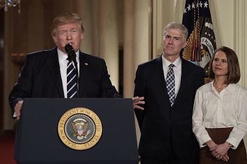Judge Neil Gorsuch (C) and his wife Marie Louise look on
