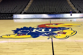 Kansas Jayhawks logo as it appears on a basketball court.
