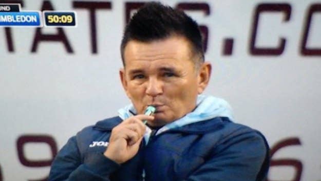 Sutton United manager caught vaping on the sidelines during a match with AFC Wimbledon.