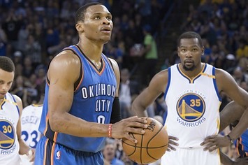 Russell Westbrook shoots a free throw with Kevin Durant in the background.