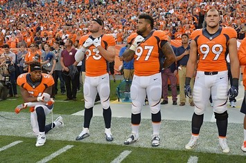 Brandon Marshall kneels during the national anthem.