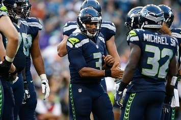 Seahawks players huddle during a preseason game.