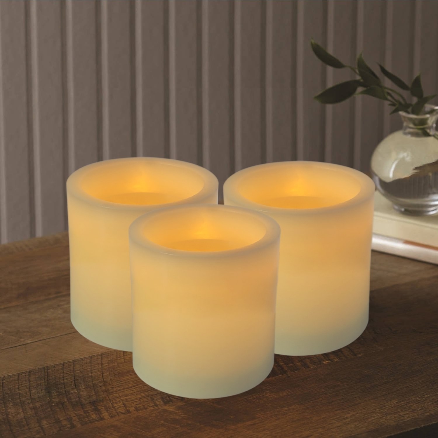 Four off white illuminated pillar candles