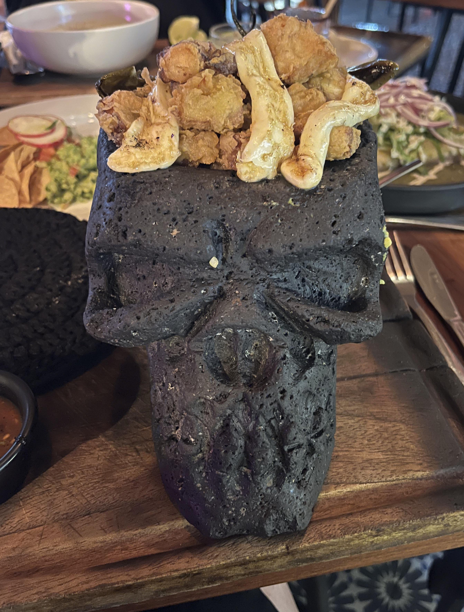 A skull with chicken wings sitting on top of it