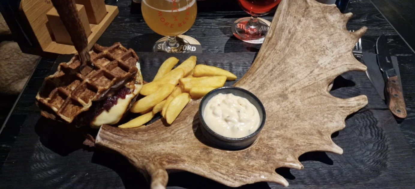 Fries and dipping sauce lying on a large antler
