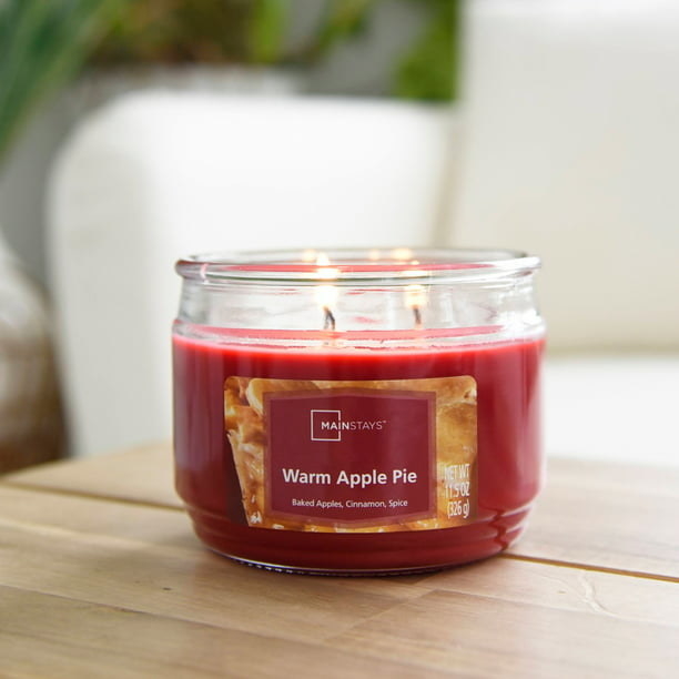 red warm apple pie candle in a glass jar