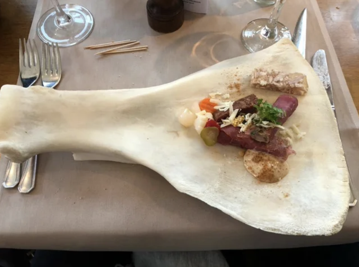 Assorted foods served on a large, real animal bone