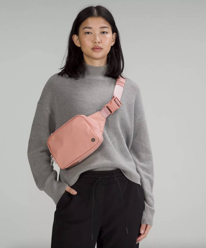 a person wearing the oversized belt bag slung across their shoulder