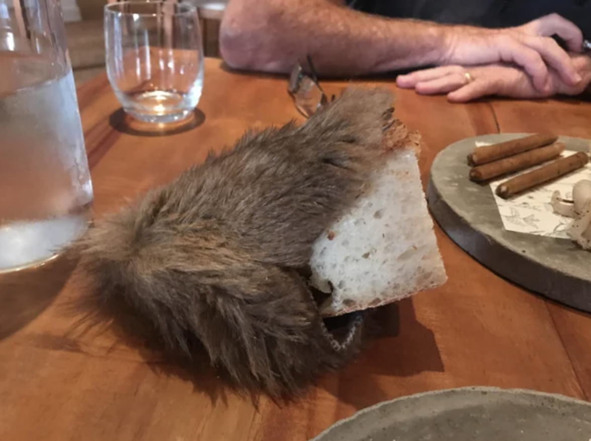 A loaf of bread served inside a pouch covered in fur