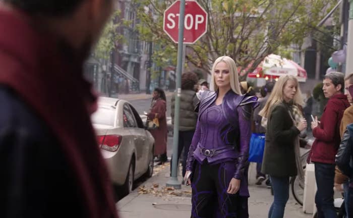Charlize in character as Cleo standing in the street