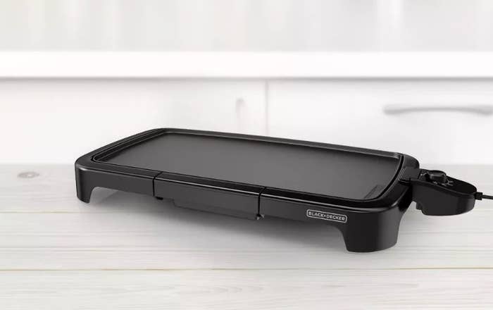 Black electric griddle on a kitchen countertop