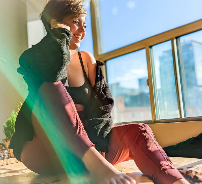 victoria wearing the dance studio joggers while sitting by a window