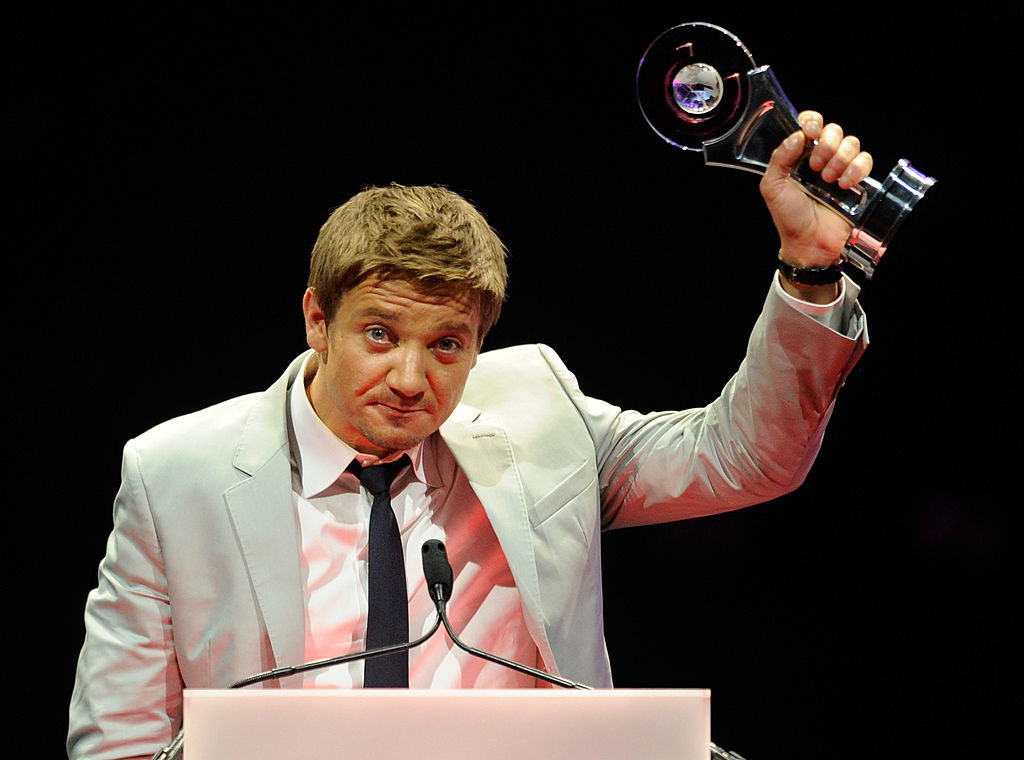 Jeremy at a podium holding up an award