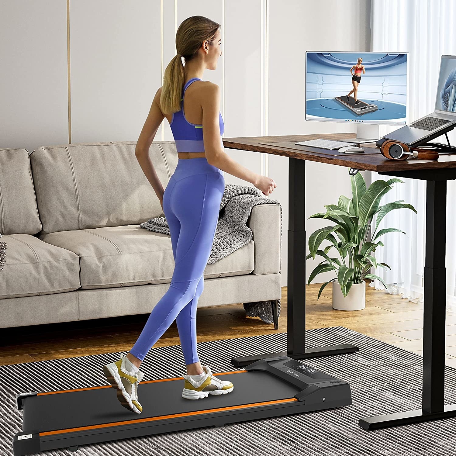 a person using the treadmill while looking a computer