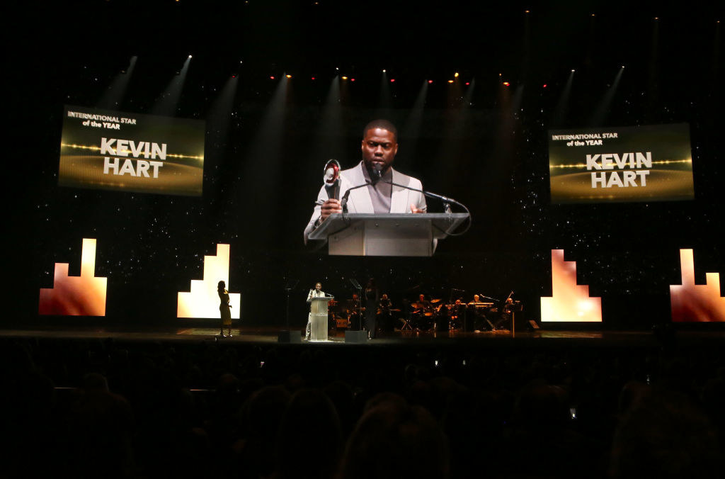 Kevin at a podium holding an award