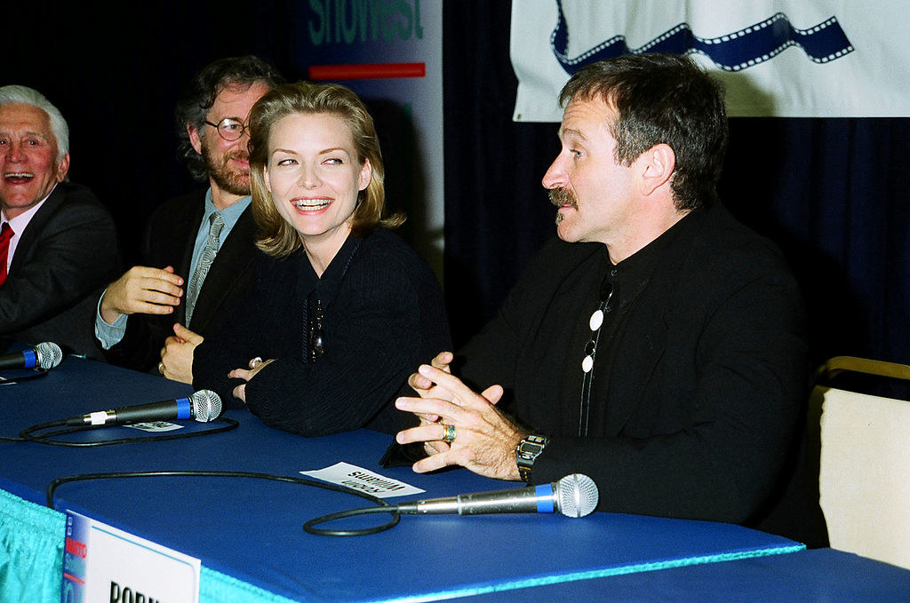 Michelle smiling and looking at Robin on a panel