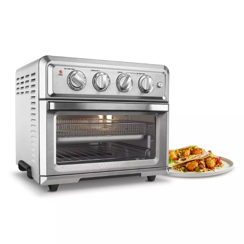 Toaster oven with a plate of food next to it