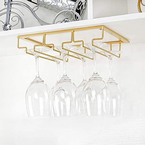 a set of wine glasses hanging on the undermounted rack