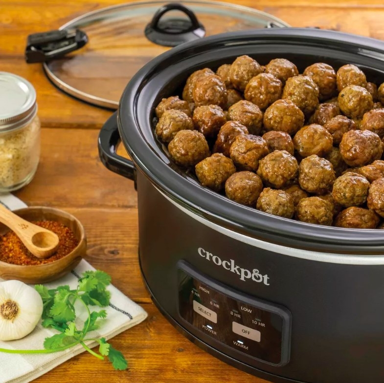 Slow cooker filled with cooked meat balls