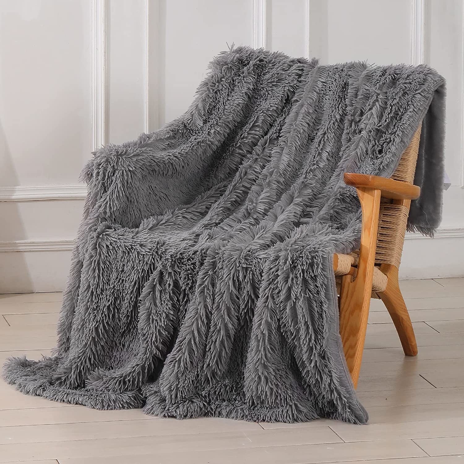 a fluffy throw blanket draped over a chair