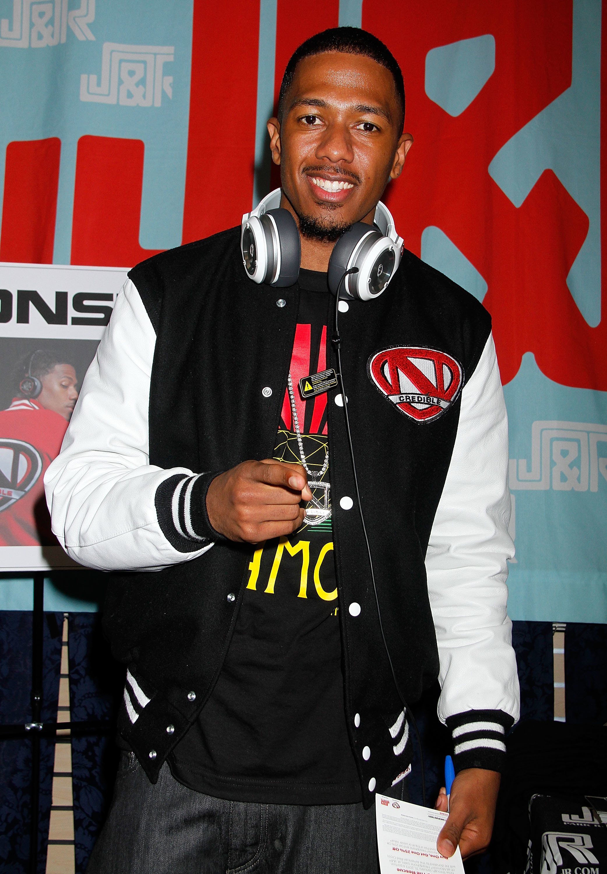 Nick Cannon smiling and pointing
