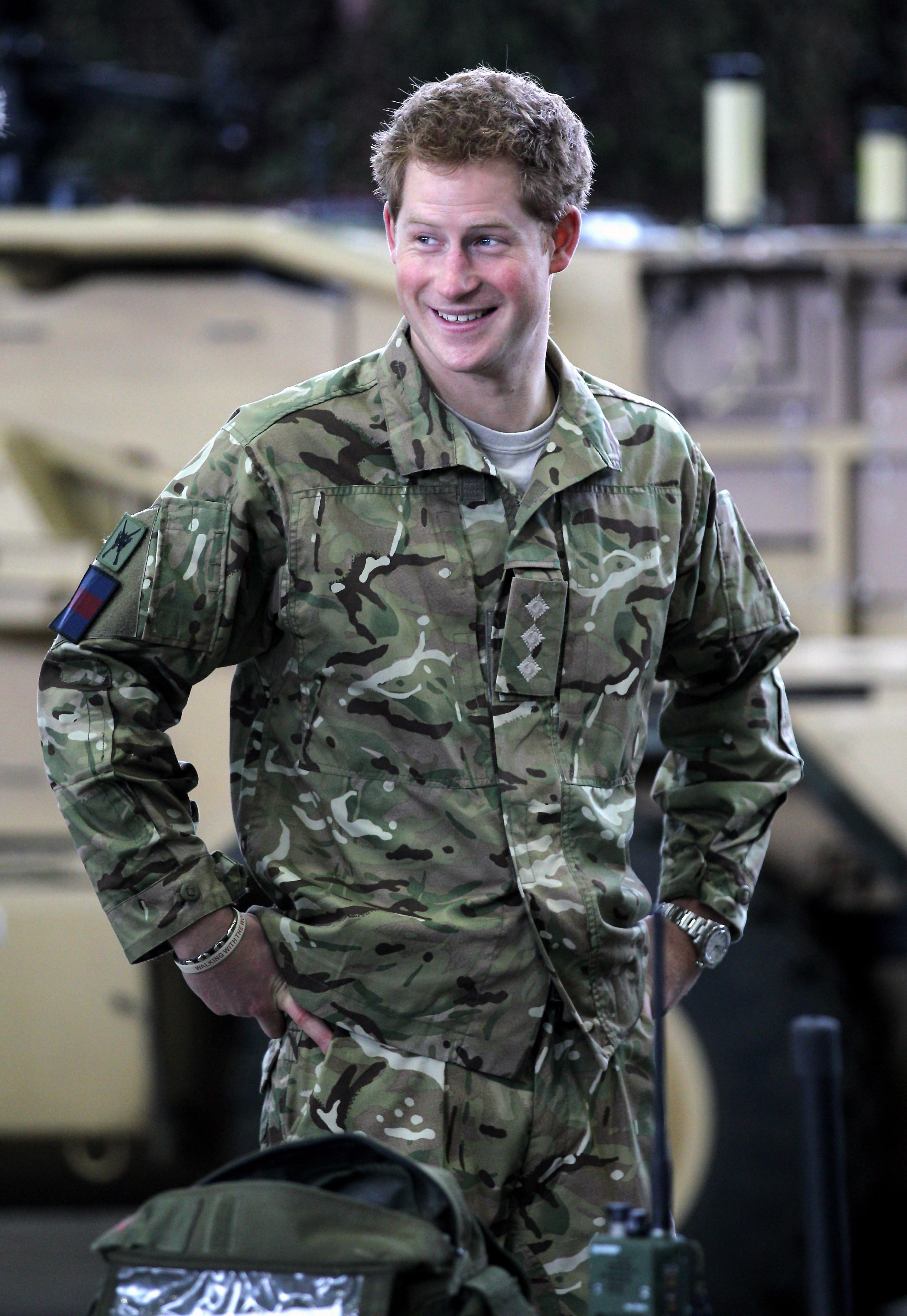 Prince Harry grinning and wearing a military uniform