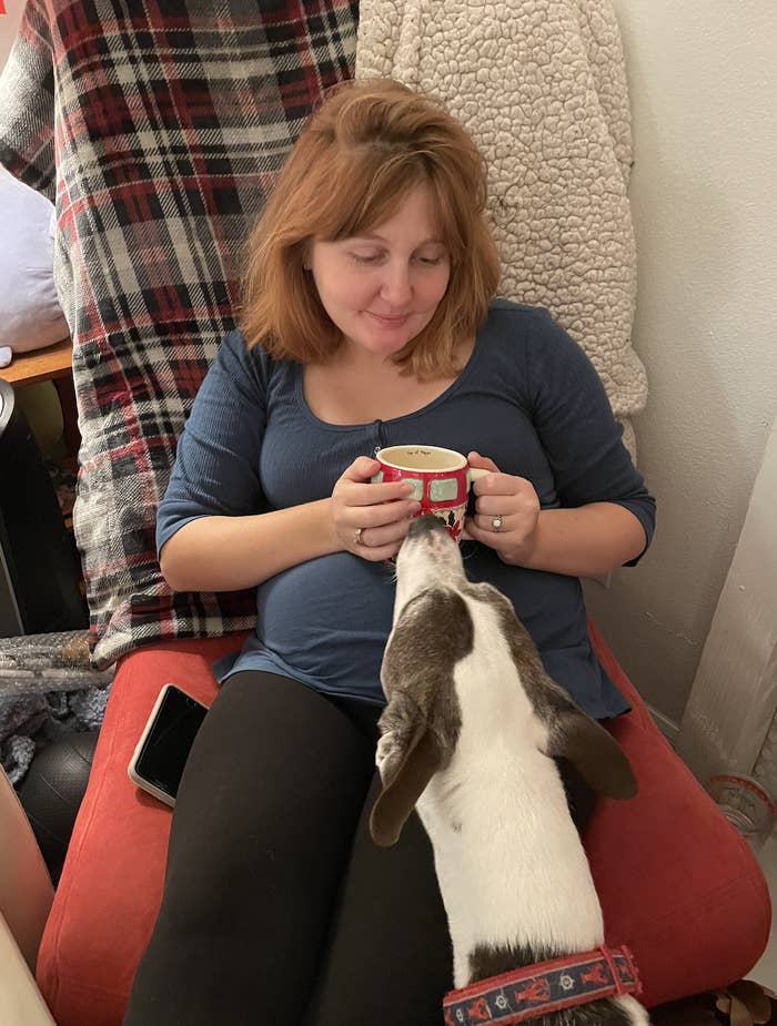 the author sitting on a couch with her dog