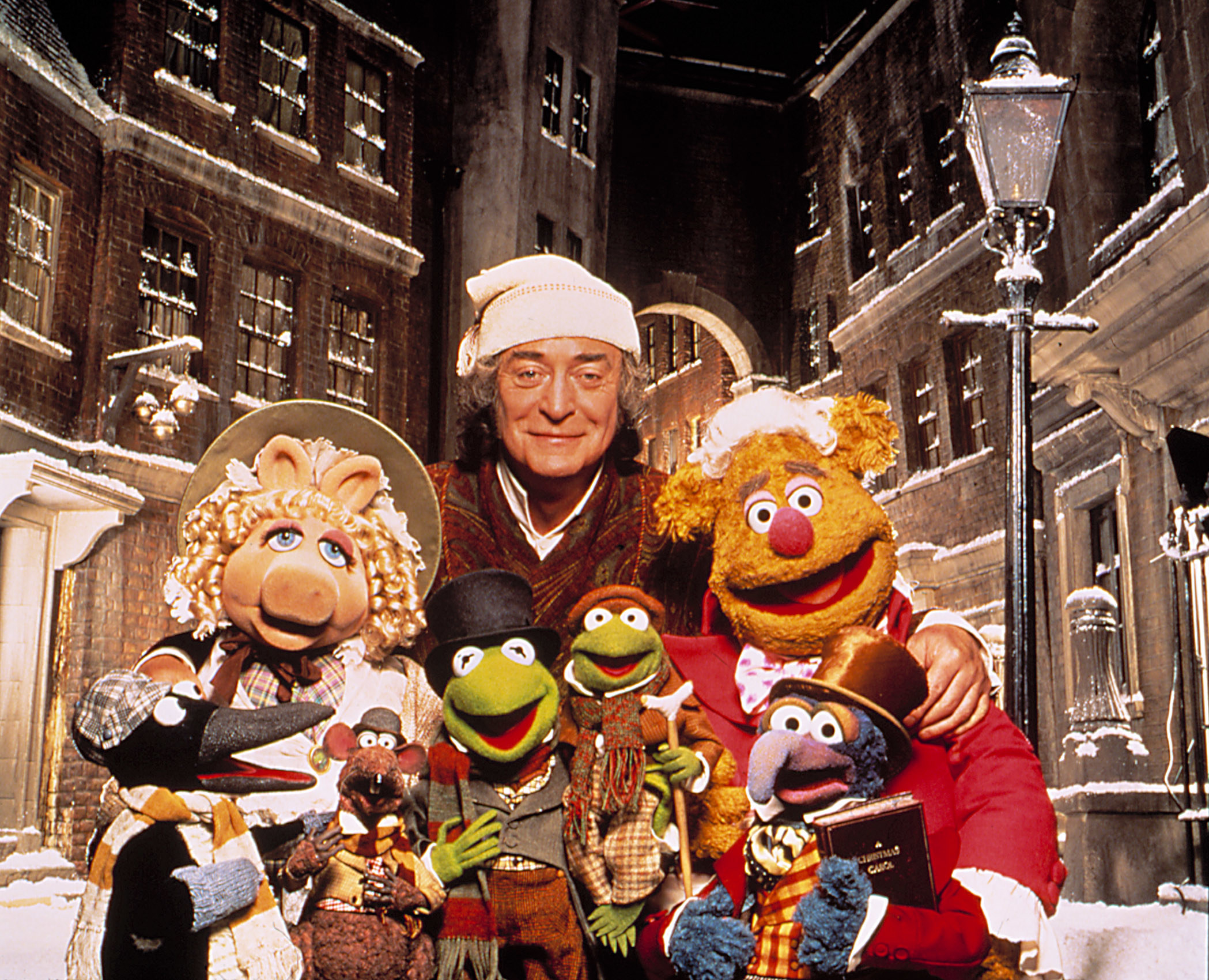 Michael Caine as Scrooge with a group of muppets