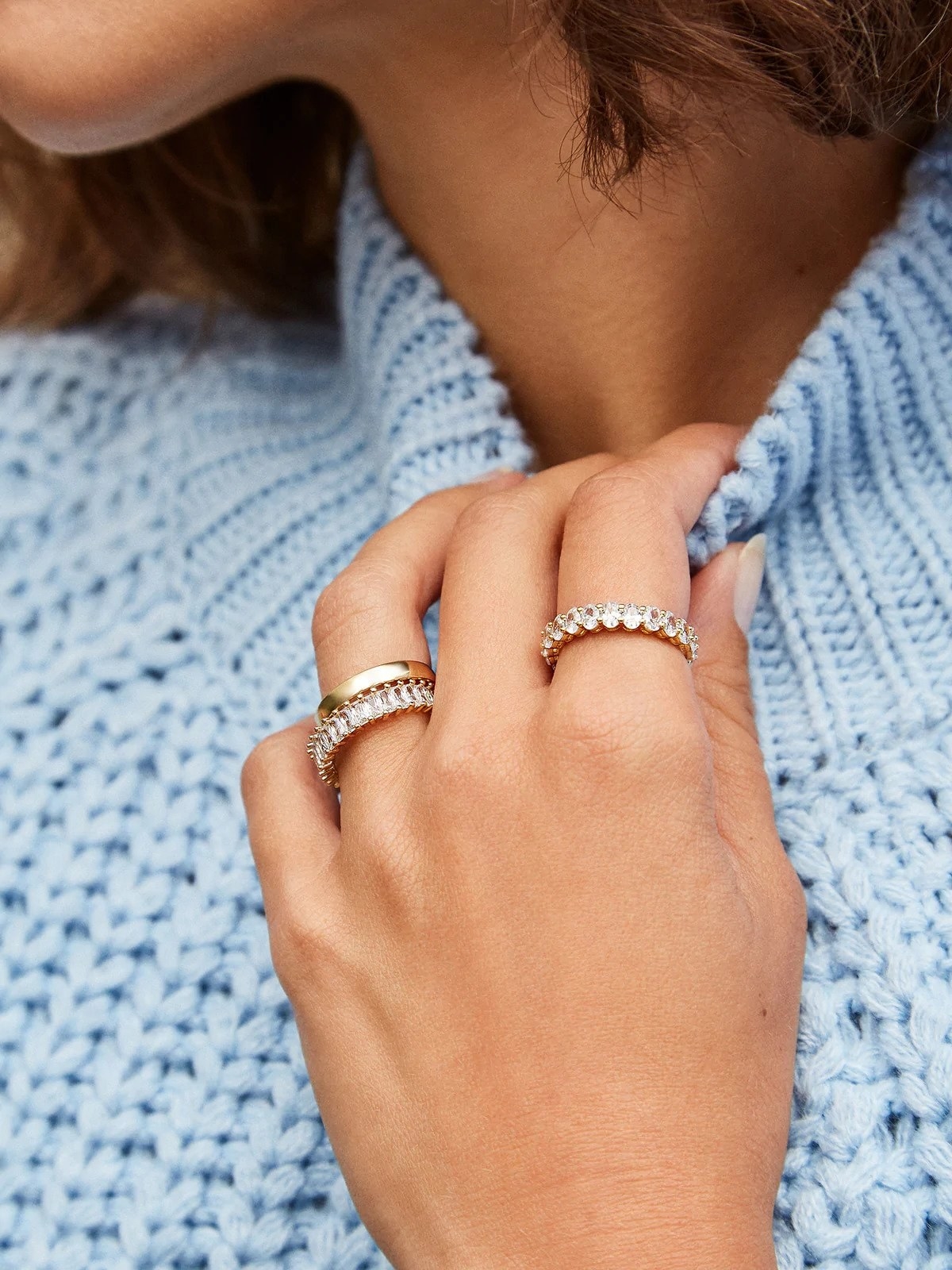 a model wearing stacked rings