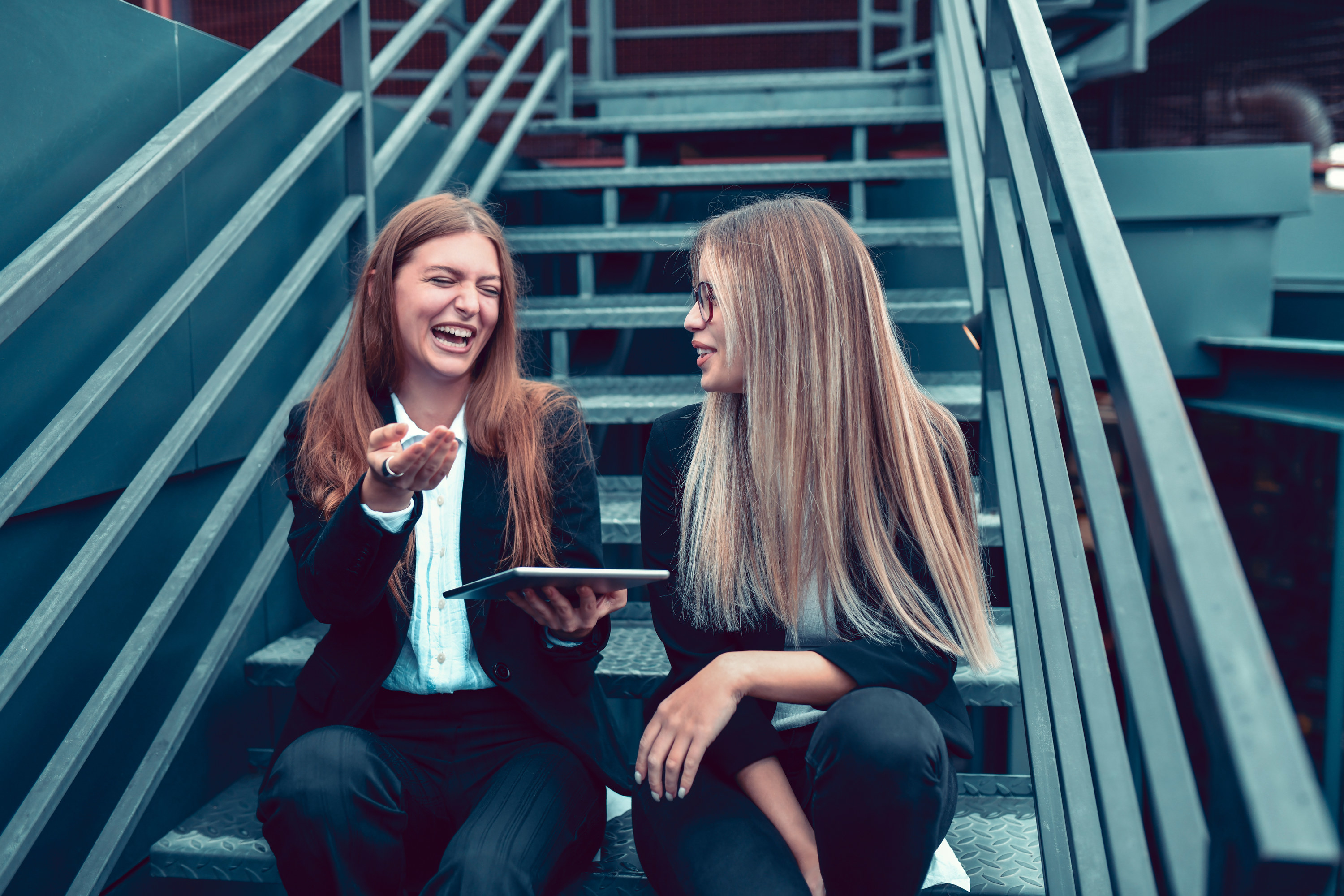 two woman talking on the stairs