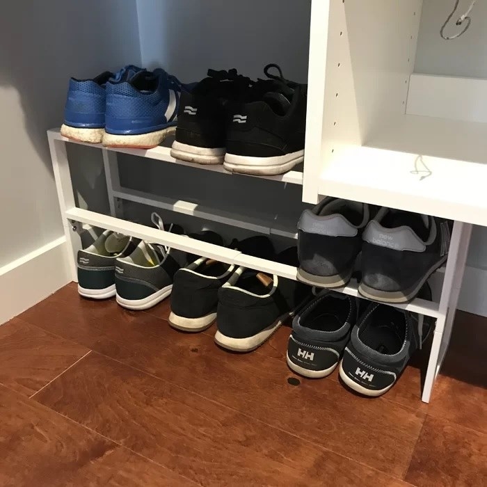 The shoe rack holding multiple pairs of shoes
