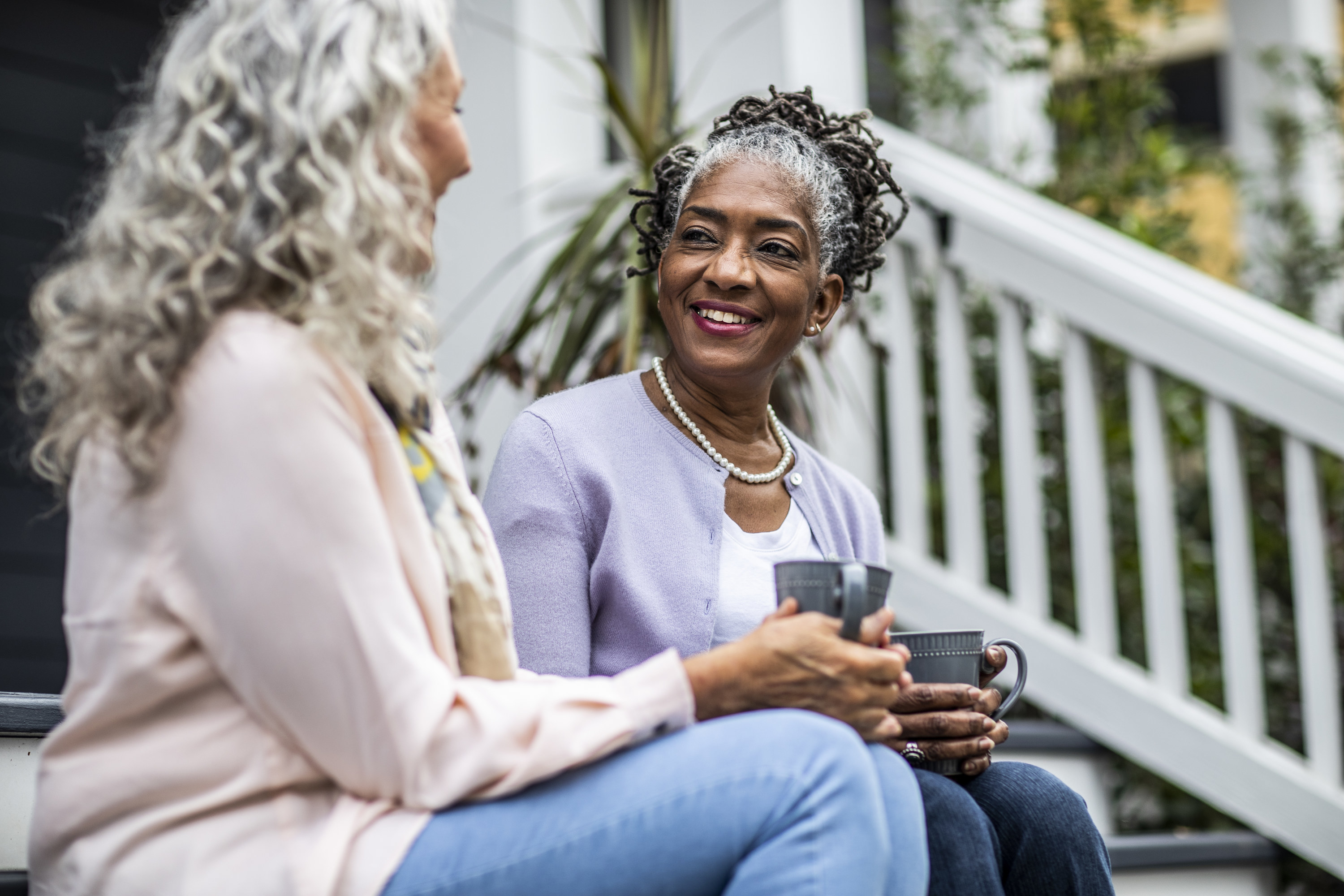 two woman talking on the porch