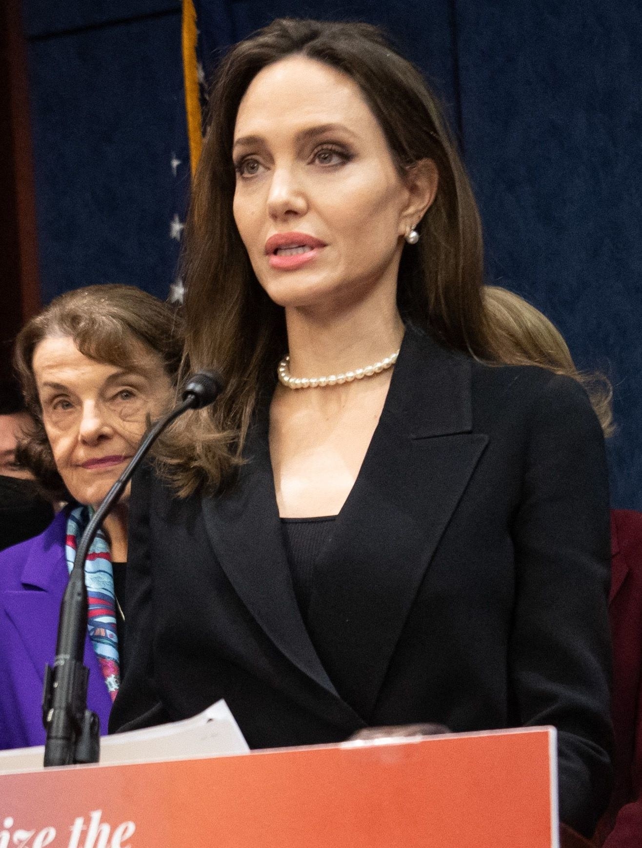 Angelina Jolie speaking at a podium