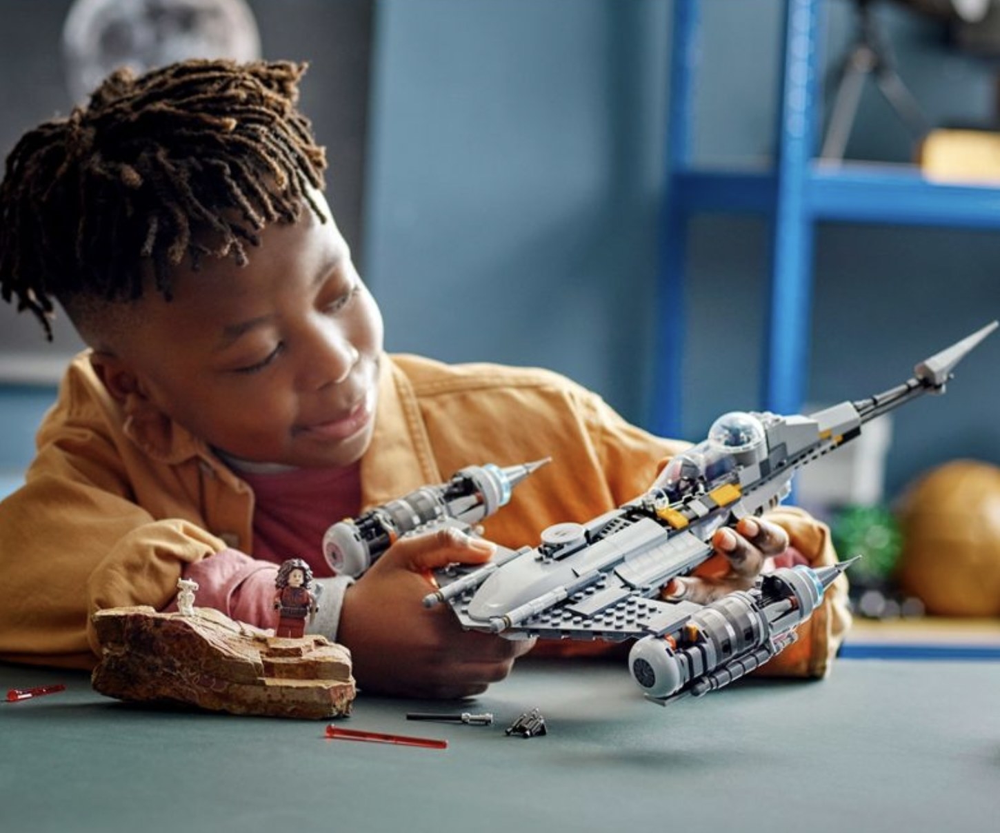child playing with the Mandalorians N-1 Starfighter Lego set
