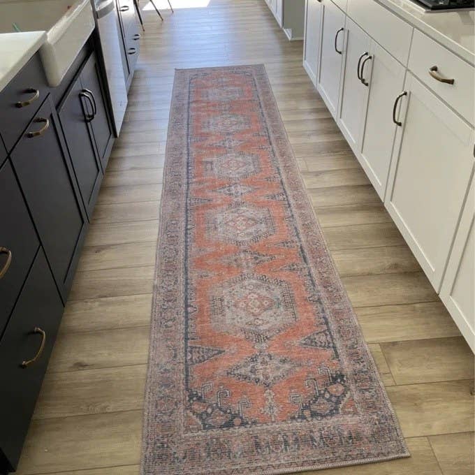 A long runner rug in the kitchen 