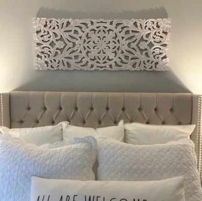 The wall art above the headboard of a bed