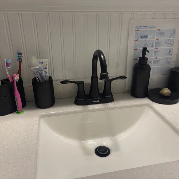 The bathroom accessory set next to the sink 