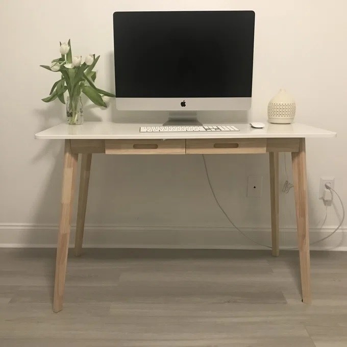 The desk in the white option with a desktop computer on it