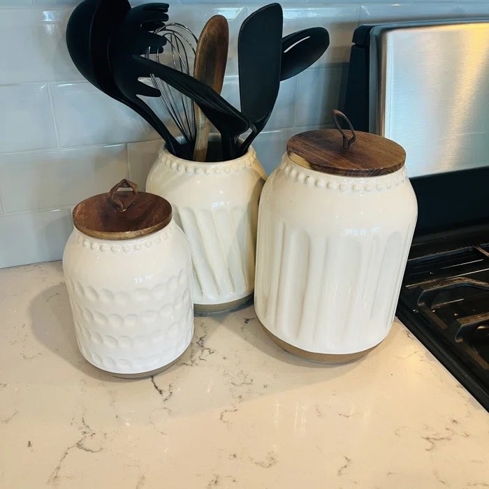 The three cannisters on a kitchen countertop