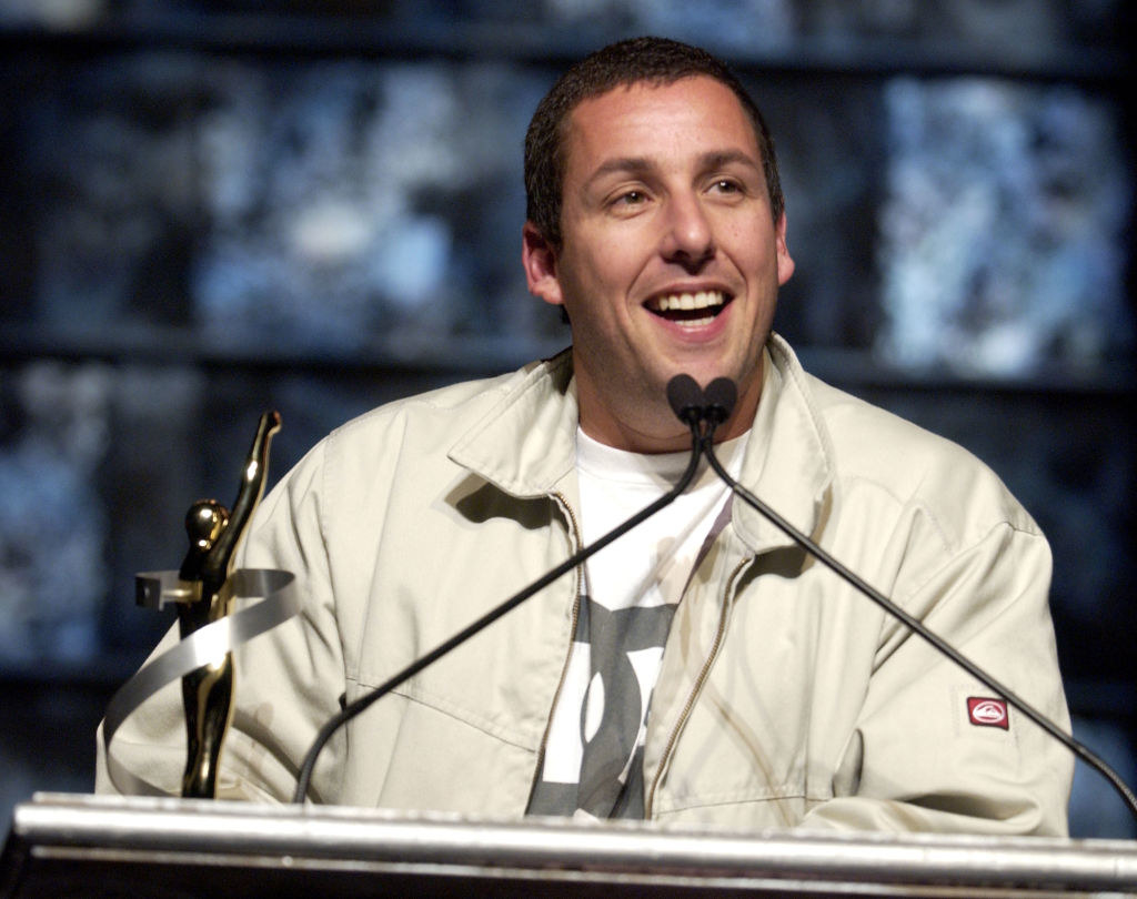 Adam at a podium with an award