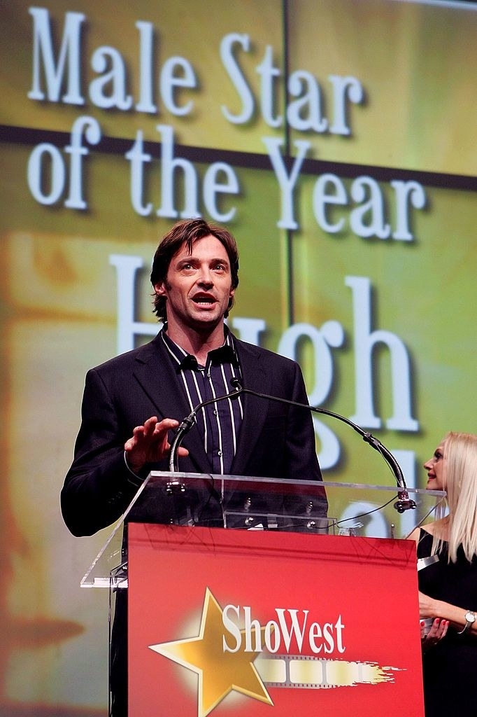 Hugh at a ShoWest podium with &quot;Male Star of the Year&quot; on the screen behind him
