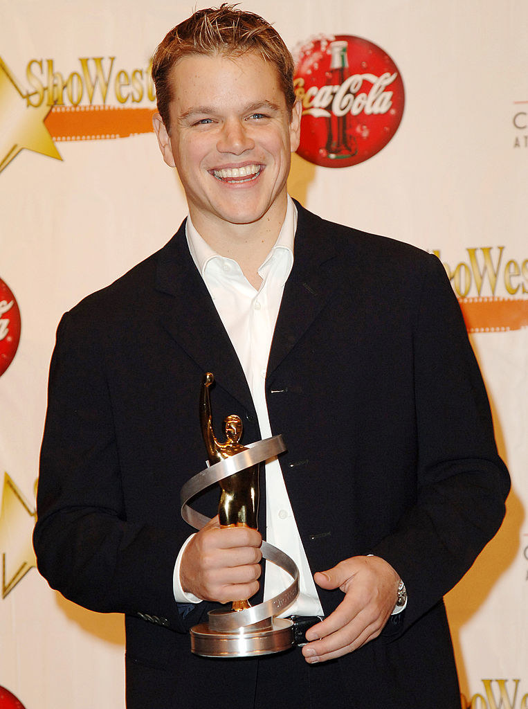 Matt smiling and holding an award