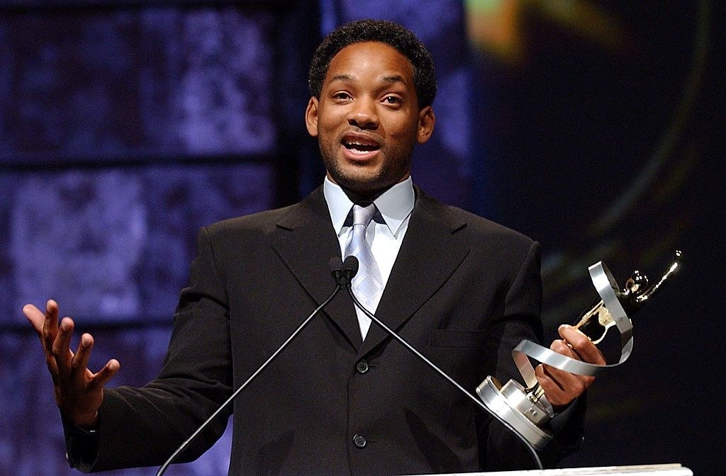 Will at a podium holding an award