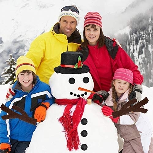 Family posing with snowman