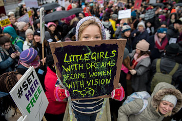 A little girl at a Time's Up rally in London.