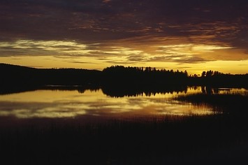 Sunset and clouds over a lake, Lakeland, Finland.