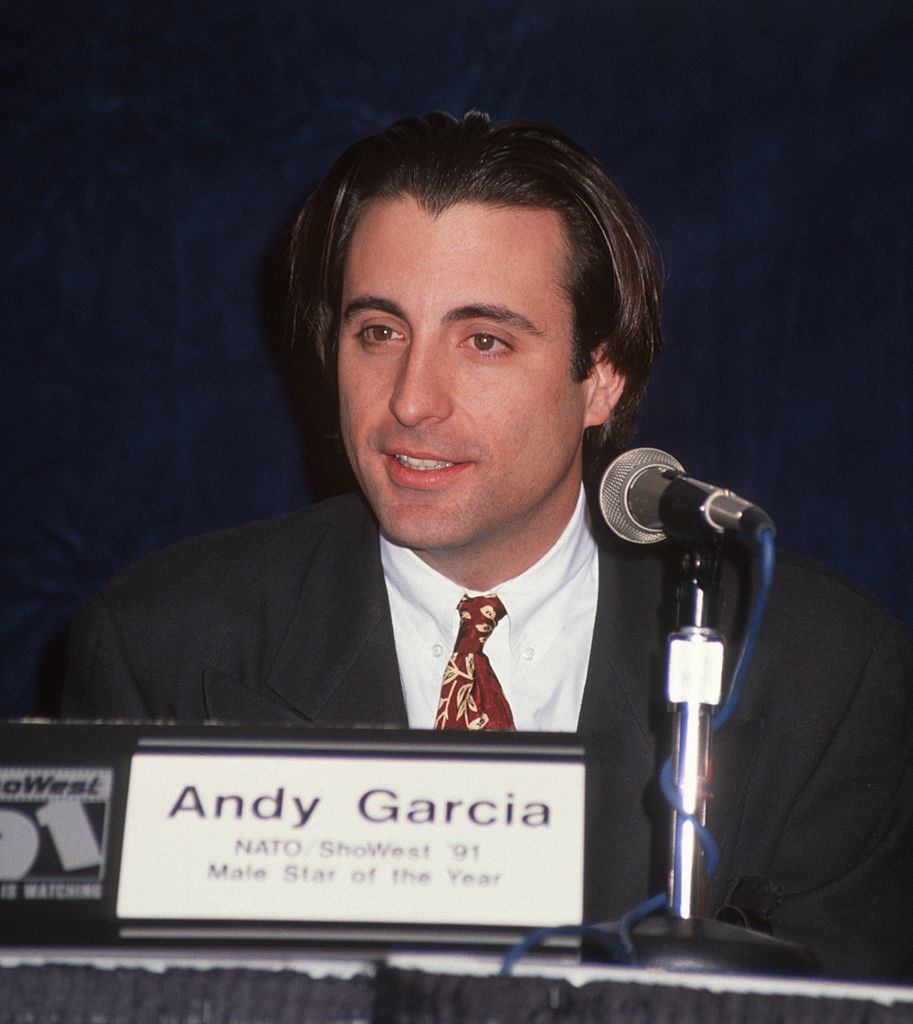 Andy seated in front of a microphone