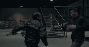 An undercover cop beats the ever-loving hell out of a goon in a warehouse