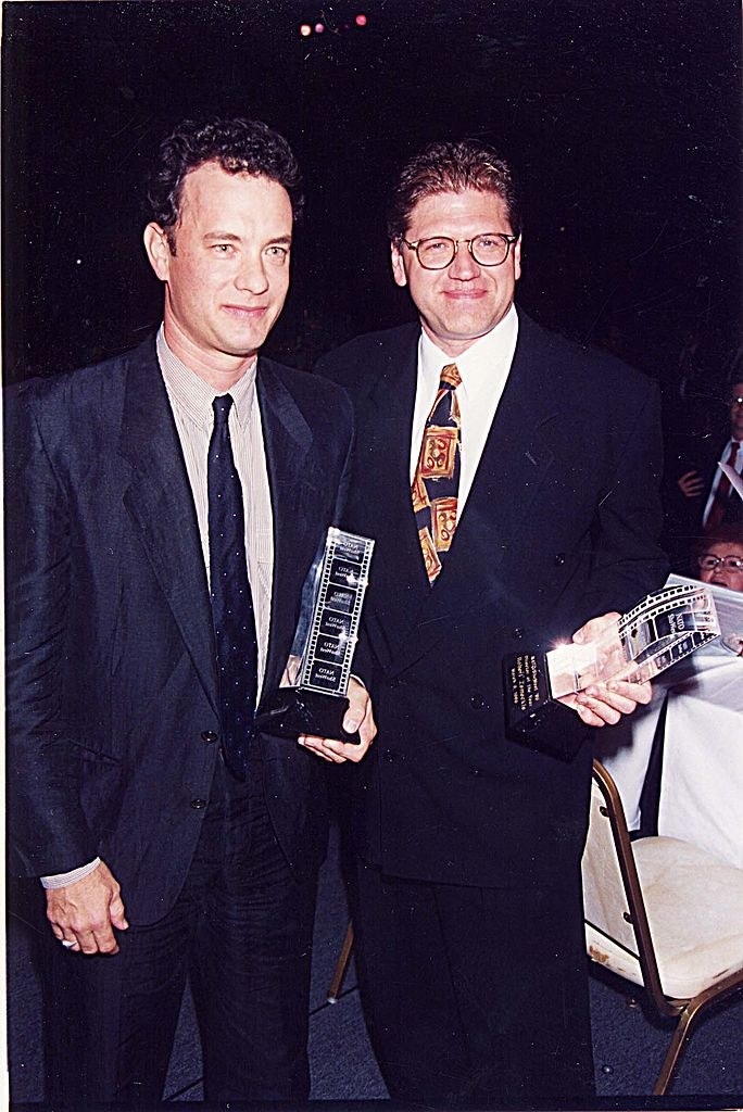 Tom and Robert both holding awards