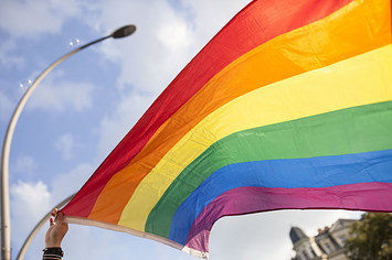 A participant is holding the pride flag.